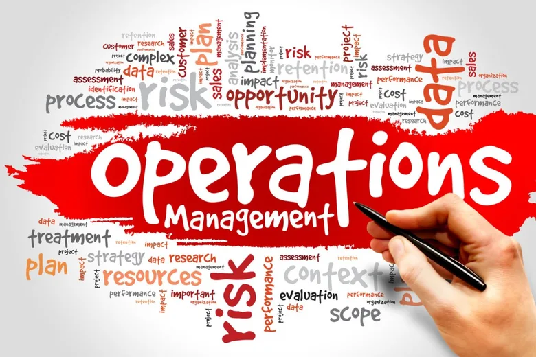 A hand writes over an operations management word cloud with a red paint stroke.